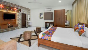 A hotel room with a bed, a TV, a wardrobe, a desk, and a bathroom. - Fabhotel Ans Kp Annex (Pune)
