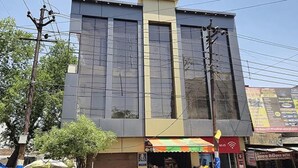 A modern building with large windows and a flat roof. - Fabhotel Devi Residency (Vrindavan)