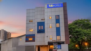 A modern building with a sign reading "fabHOTELS" at the top. - Fabhotel Galaxy Inn I (Pune)
