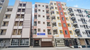A multi-story hotel building with balconies, a visible 'fabHOTELS' sign, and a clear sky. - Fabhotel Golden Eagle Executive (Paud)