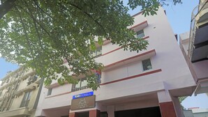 A multi-story building with a sign for 'Tab Hotels' and a partially visible name 'Torkay'. - Fabhotel Vivek Inn (Prayagraj)
