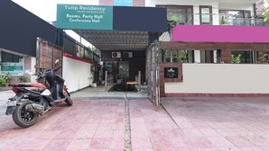 A building entrance with a sign for Tulip Residency, Rooms, Party Hall, and Conference Hall. - Fabhotel Tulip Residency (Gurugram)