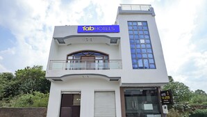 A modern hotel with a prominent 'fab hotels' sign, a balcony with glass railings, and a sign for 'Hotel The Lotus' indicating full accommodation rooms. - Fabhotel Lotus (Agra)