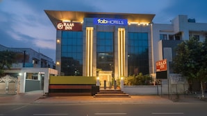 A modern building with a sign for 'RAAS INN' and 'fabHOTELS'. - Fabhotel Raas Inn (Lucknow)