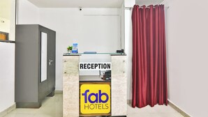 A reception desk with a sign reading "Reception" and "fab hotels". - Fabhotel Raas Inn (Lucknow)