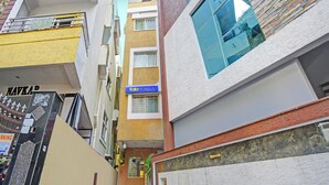 A multi-story building with a 'fabHOTELS' sign, a 'NAVKAP' sign, and a 'PARKING' sign. - Fabhotel Ayaansh Himayatnagar (Hyderabad)