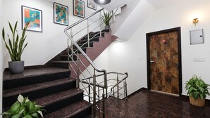A staircase with metal railings, a potted plant, and a door with a number 201 sign. - Via Diamond Key (New Delhi)