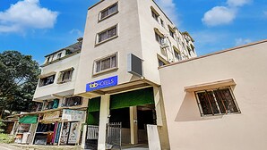 A multi-story building with a sign for 'fabHOTELS' on the ground floor. - Via Pink House (Pune)