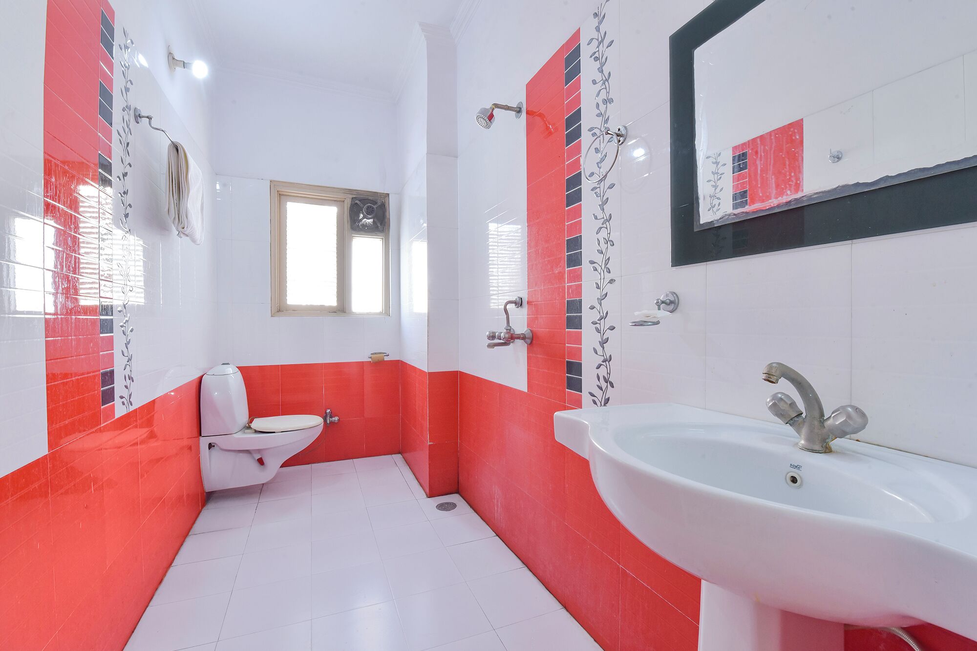 A bathroom with a toilet, sink, and shower.