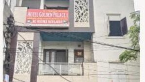 A building with a sign for 'Hotel Golden Palace' and a motorcycle parked in front. - Fabhotel Golden Palace I (Ghaziabad)