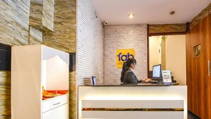 A reception desk with a sign reading "fab hotel" and a computer monitor. - Fabhotel Atithi (New Delhi)