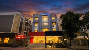 A hotel with a modern facade, a prominent 'fabHOTELS' sign, and a well-lit entrance. - Fabhotel Atithi (New Delhi)