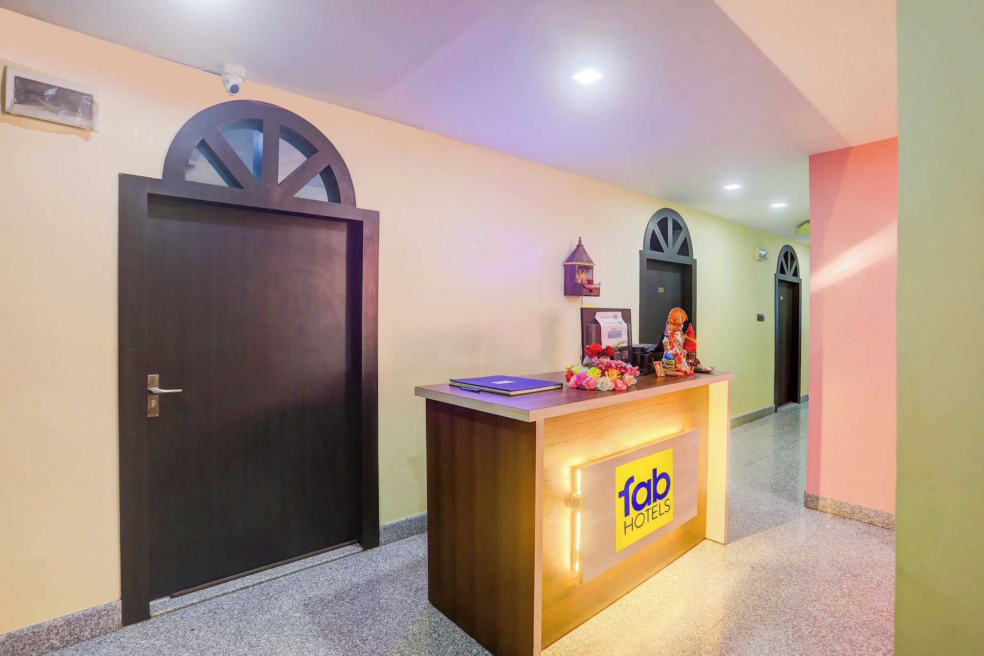 A hotel reception desk with a sign reading "fab hotels".
