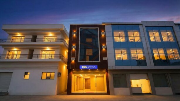 A modern building with a 'fab hotels' sign, featuring multiple floors with balconies and large windows. - Fabhotel Clayton (New Delhi)