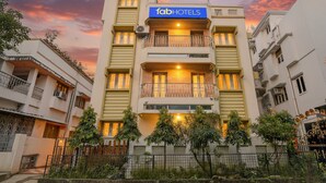 A multi-story building with a 'fabHOTELS' sign, featuring balconies, windows, and a gated entrance. - Fabhotel A2 (Barasat)
