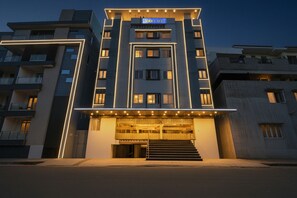 A modern hotel with a central entrance, multiple floors, and a prominent sign. - Fabhotel Shree Mohan Palace (Visakhapatnam)