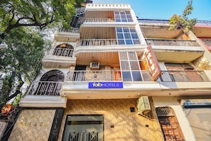 A multi-story building with balconies, a sign for 'Tab Hotels', and a partially visible sign for 'Shiv Palace'. - Fabhotel Shiv Palace (New Delhi)