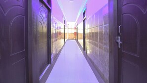 A hallway with doors on both sides, leading to rooms. - Fabhotel Park Avenue (Lucknow)