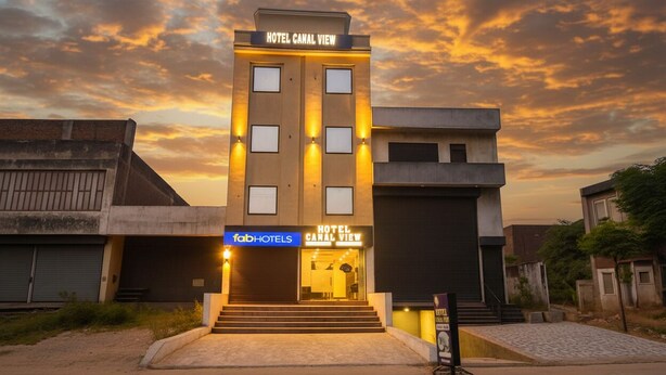 A hotel named "Hotel Canal View" with a modern facade, a visible entrance, and a sign indicating "FabHotels". - Fabhotel Canal View (Ludhiana)
