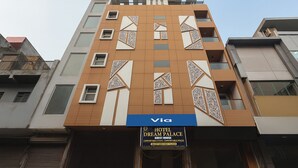A hotel building with a sign for 'Hotel Dream Palace' and 'Guest House' on the ground floor. - FabHotel Dream Palace (New Delhi)