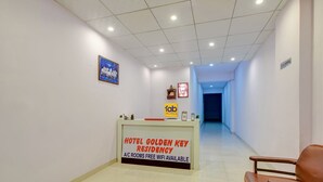 A hotel reception area with a reception desk labeled 'HOTEL GOLDEN KEY RESIDENCY' and 'A/C ROOMS FREE WIFI AVAILABLE'. - Fabhotel Golden Key Residency (New Delhi)