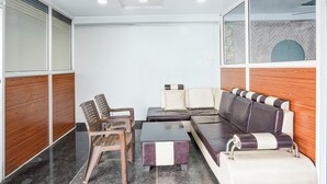 A modern room with a sofa, chairs, and a small table. - Fabhotel Imperial Blue (Nagpur)