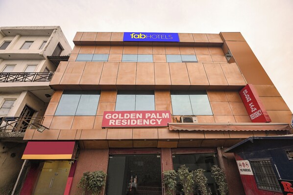 A building with a sign for 'Golden Palm Residency' and a 'Fab Hotels' sign above it. - Fabhotel Golden Palm (New Delhi)