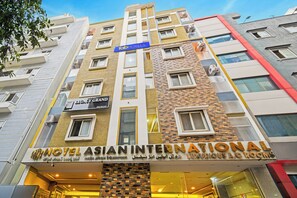 A hotel with multiple floors, including a visible sign for 'Hotel Legacy Grand' and 'Hotel Asian International'. - Fabhotel Asian International (Hyderabad)