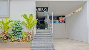 A staircase leading to a building entrance with a sign reading "ASHRAY". - Fabhotel Aashray (Hyderabad)