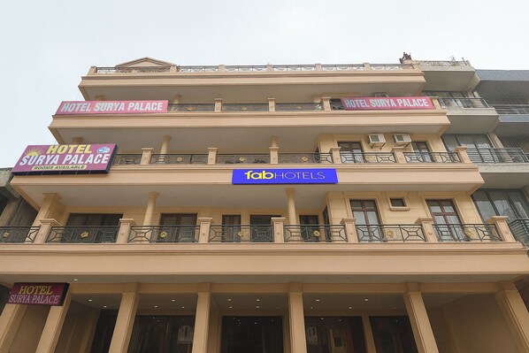 A multi-story hotel with balconies and a sign indicating 'Hotel Surya Palace.' - Fabhotel Surya Palace 1 (Chandigarh)