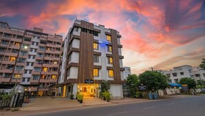A hotel with a modern design, featuring a prominent entrance and multiple floors. - Fabhotel Panchsheel Crown (Pune)