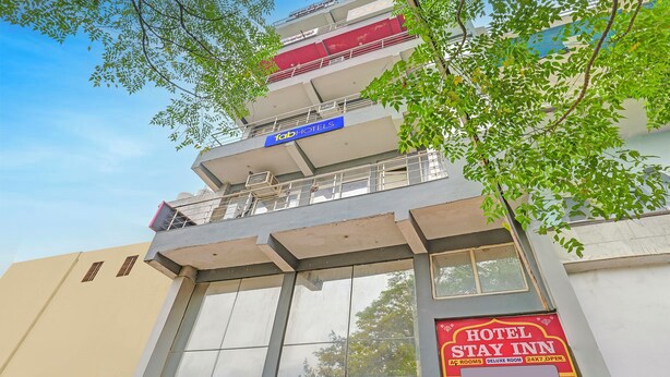 A multi-story building with a sign for 'fabHOTELS' and a 'HOTEL STAY INN' sign below. - Fabhotel Stay Inn I (Noida)
