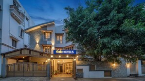 A hotel entrance with a sign reading "fabHOTELS" and a gated driveway. - FabHotel Srinidhi Stay Inn - HSR Layout (Bangalore)