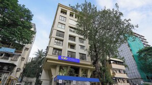 A multi-story building with a sign for 'fabHOTELS' on the ground floor. - Fabhotel Freedom Star (Mumbai)