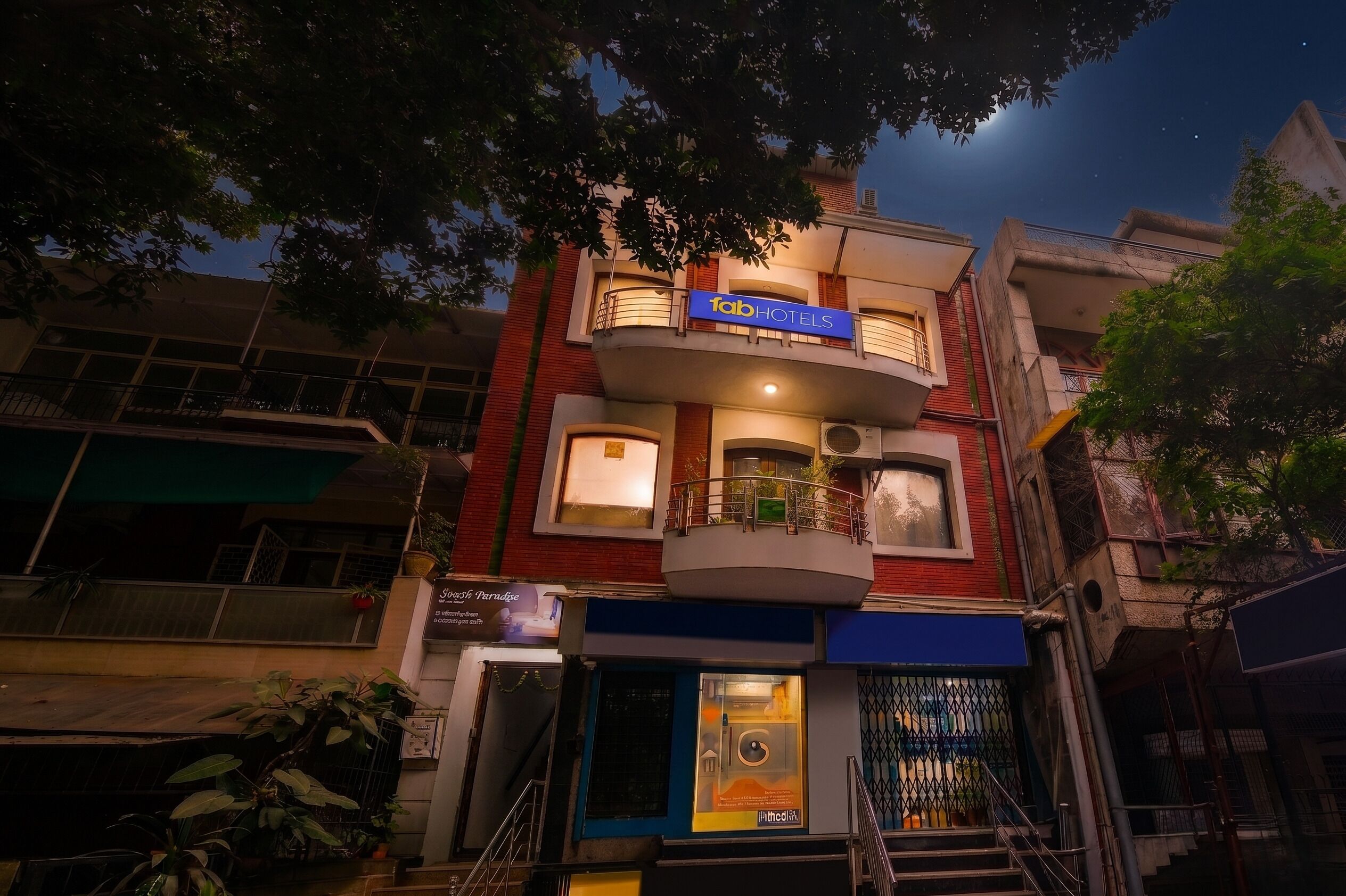 A multi-story building with a sign for 'Tab Hotels' and a visible entrance.