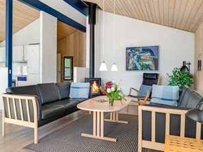 A modern living room with a fireplace, a dining table, and a sofa. - "Melita" - 2km from the sea by Interhome (Blokhus)