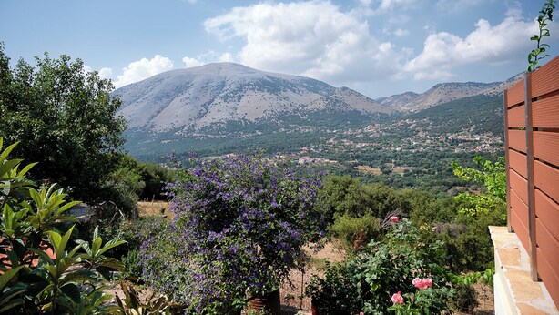 A mountainous landscape with a view of a valley and a town.