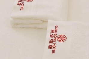 Folded white towels with 'GUM GONG HOTEL' text and logo. - Guan Gong Hotel Jin Shang Development Jonker Street (Melaka)