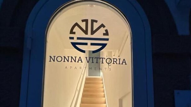 A staircase leading to an entrance with a sign reading "NONNA VITTORIA APARTMENTS". - Nonna Vittoria Apartments (Mola di Bari)