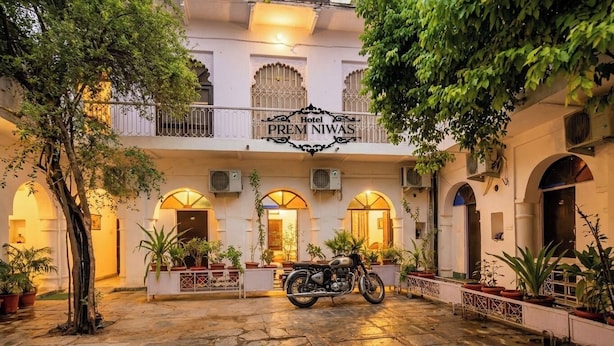 A hotel named "Hotel Prem Niwas" with a courtyard, potted plants, and a motorcycle. - Prem Niwas 300-year-old Heritage Boutique Haveli (Udaipur)