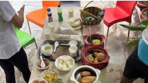 A table with various dishes and utensils, likely for a meal. - Prem Niwas 300-year-old Heritage Boutique Haveli (Udaipur)