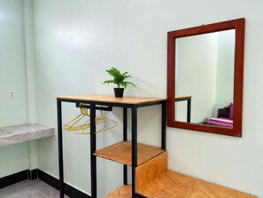 A corner room with a wooden table, a mirror, and a potted plant. - AHHA Bungalow Kampot (Kampot)