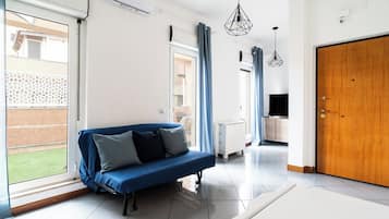 Apartment, 1 Bedroom | Living area | 30-inch TV with satellite channels