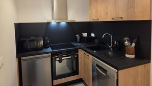 A modern kitchen with a dishwasher, oven, and stove. - Apartment 3R, 6 ppl, Valmorel with Parking (Valmorel)