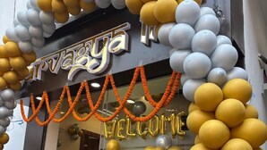 A building entrance decorated with balloons and garlands, with a sign that reads "Welcome". - Sarvagya Inn (Varanasi)