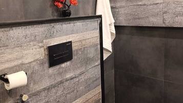 Bidet, towels, soap, toilet paper