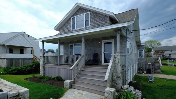 A two-story house with a covered porch, stone steps, and a small front yard. - Ocean views galore. York Beach at your finger tips (York Beach)