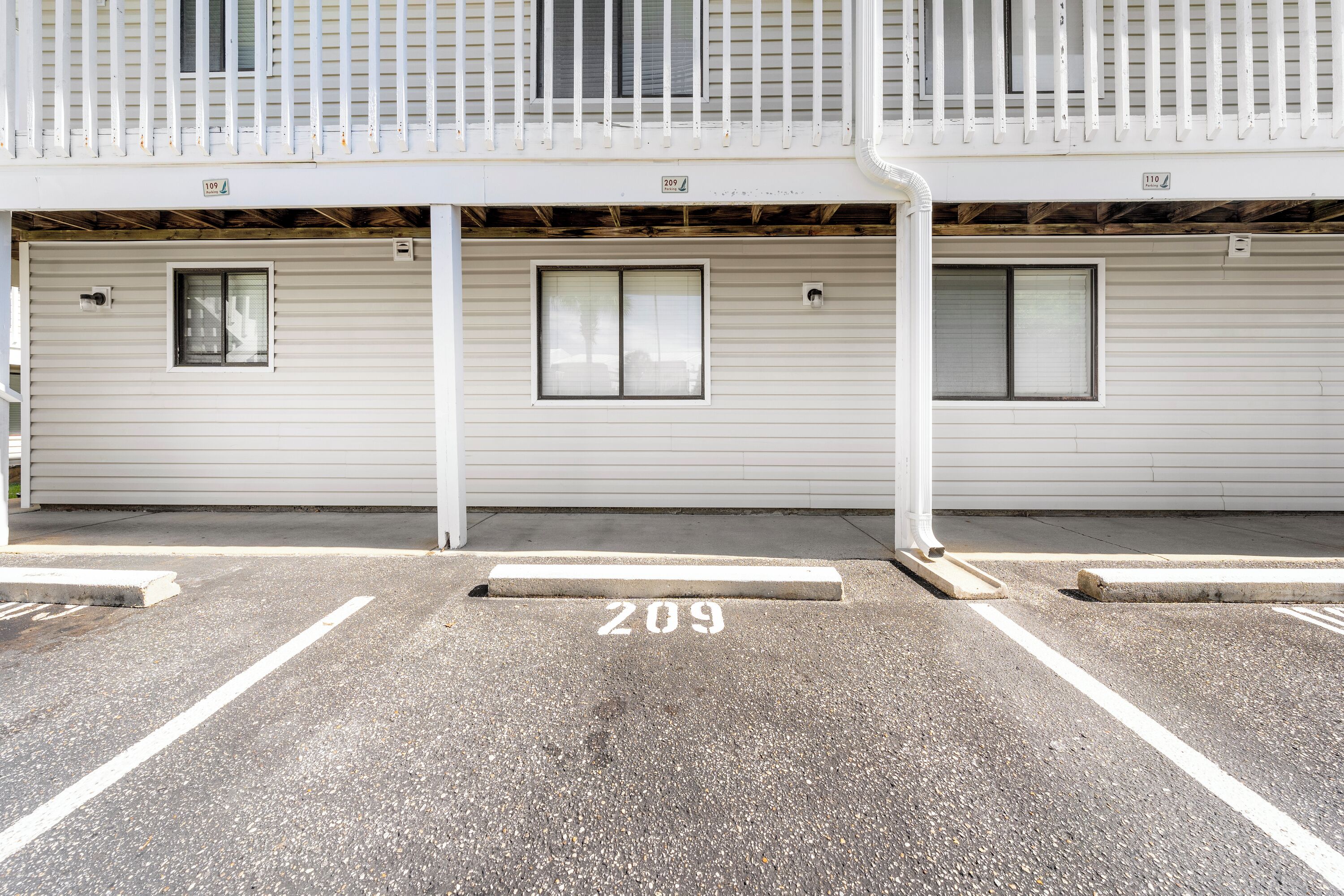 A building with a garage door marked with the number 209.