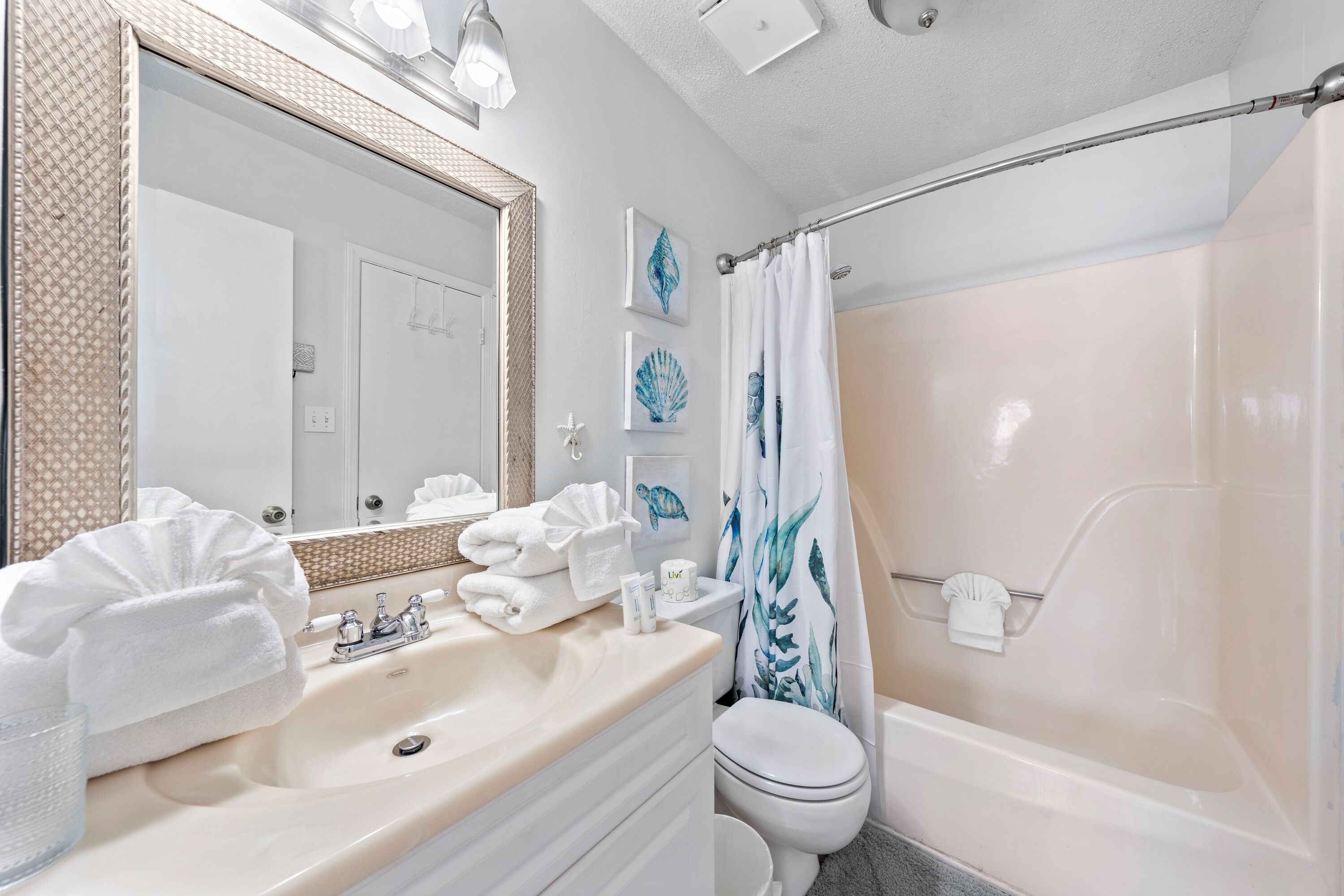A bathroom with a sink, toilet, and bathtub.