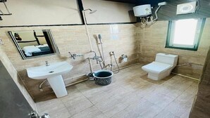 A bathroom with a sink, toilet, and shower. There is a mirror above the sink and a window on the right wall. - Daosri The Inn (Barangabari)